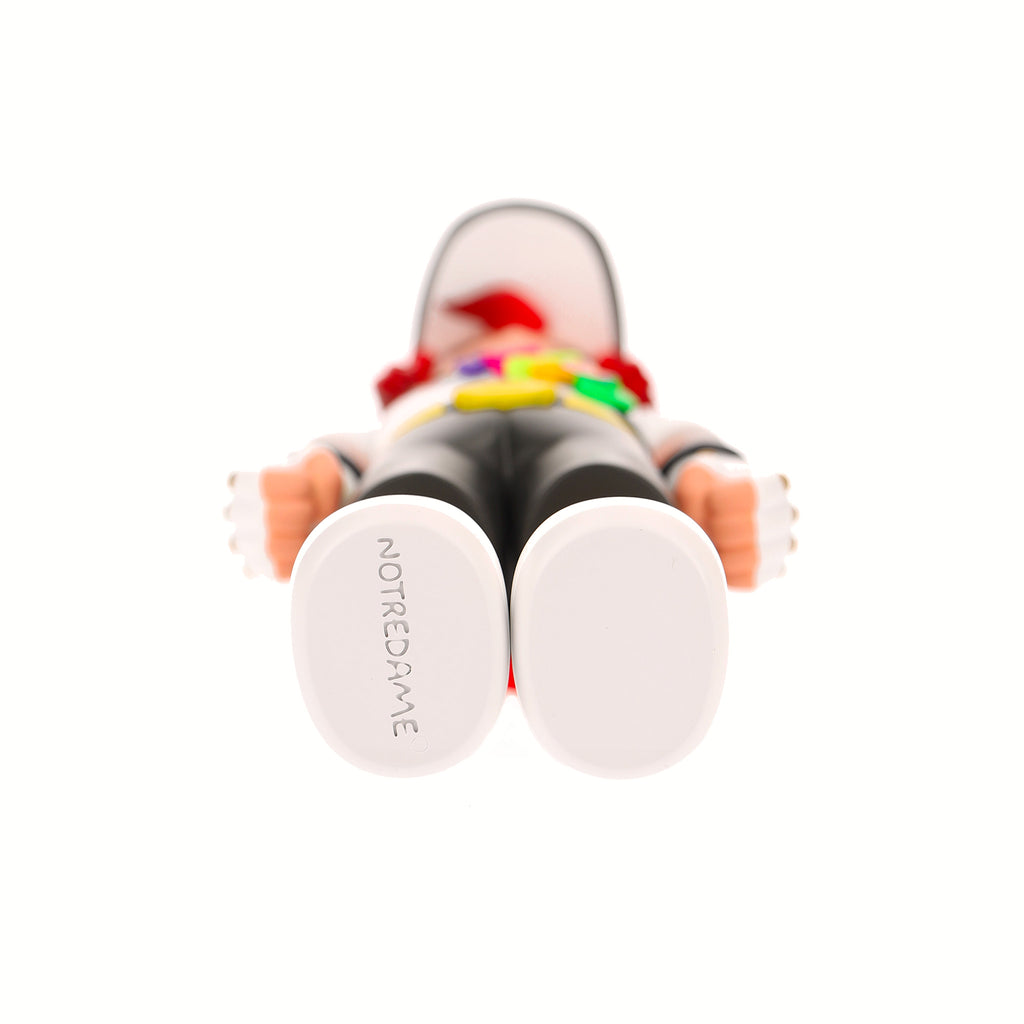 Toy figure with 'Notredame' branding on a white background